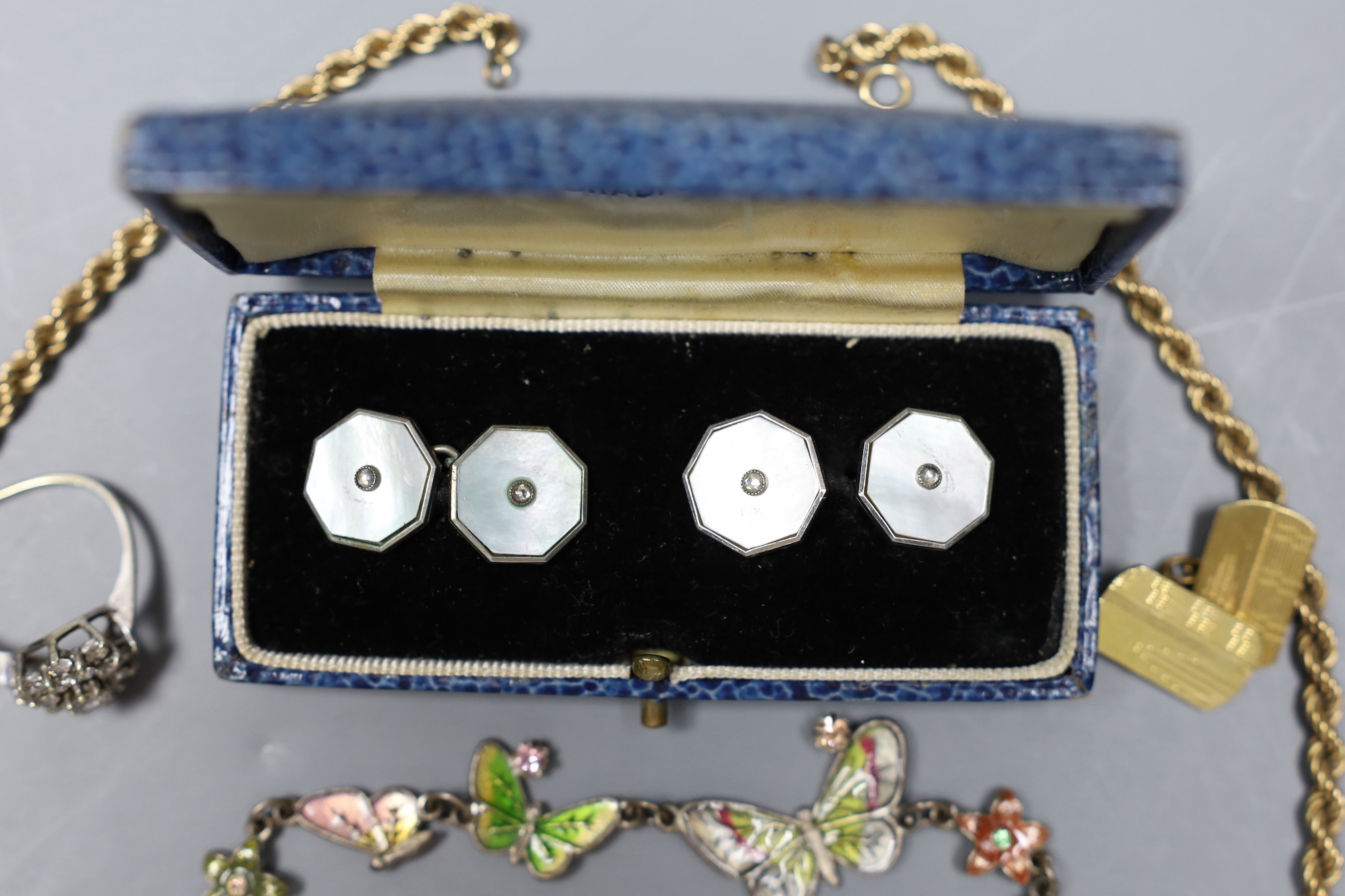 A modern 9ct gold rope twist chain, 5.2 grams, a white metal and enamel butterfly link bracelet, a pair of mother of pearl and base metal cufflinks in box, a gold plated cufflink and a silver dress ring.